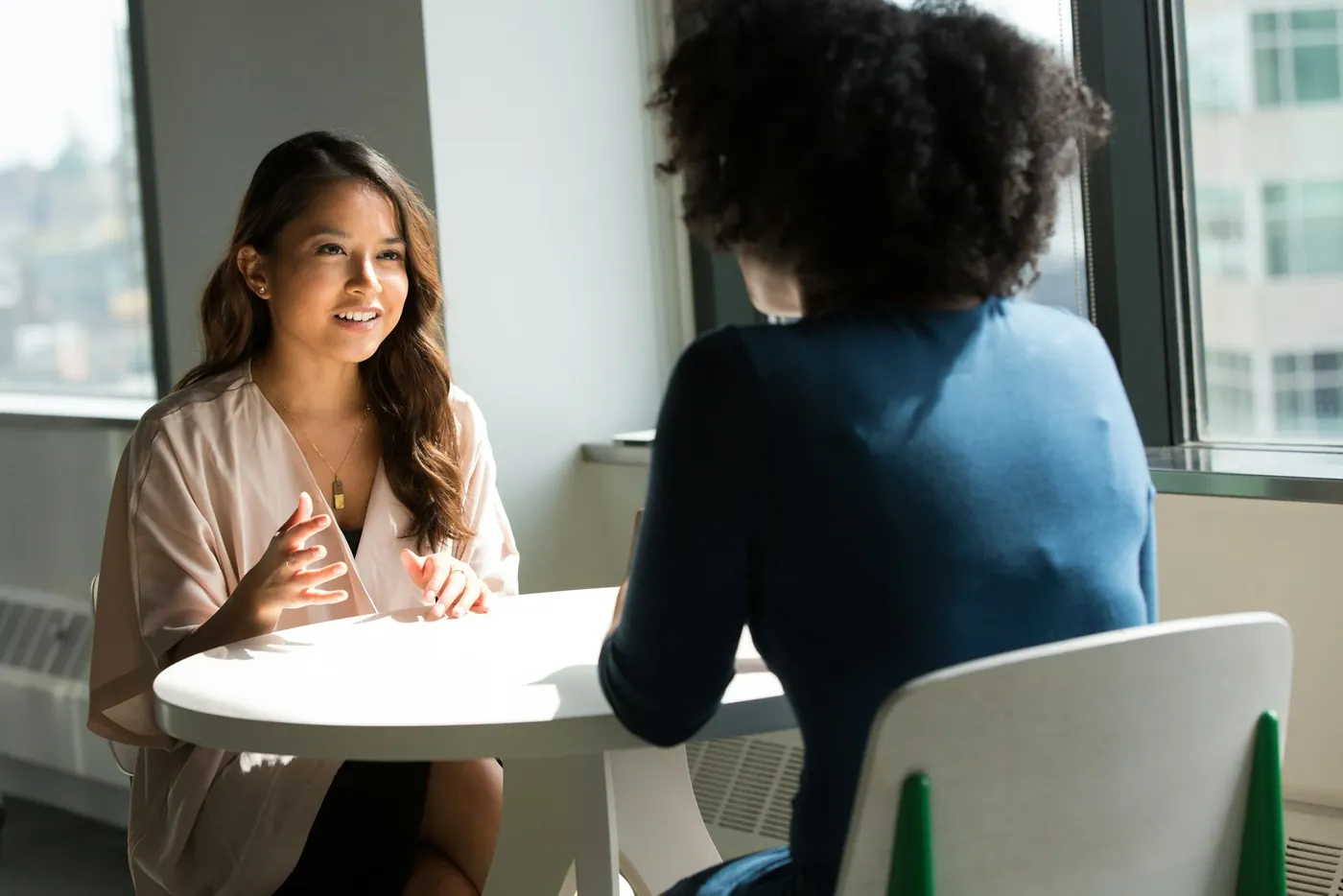 Two students talking across a table