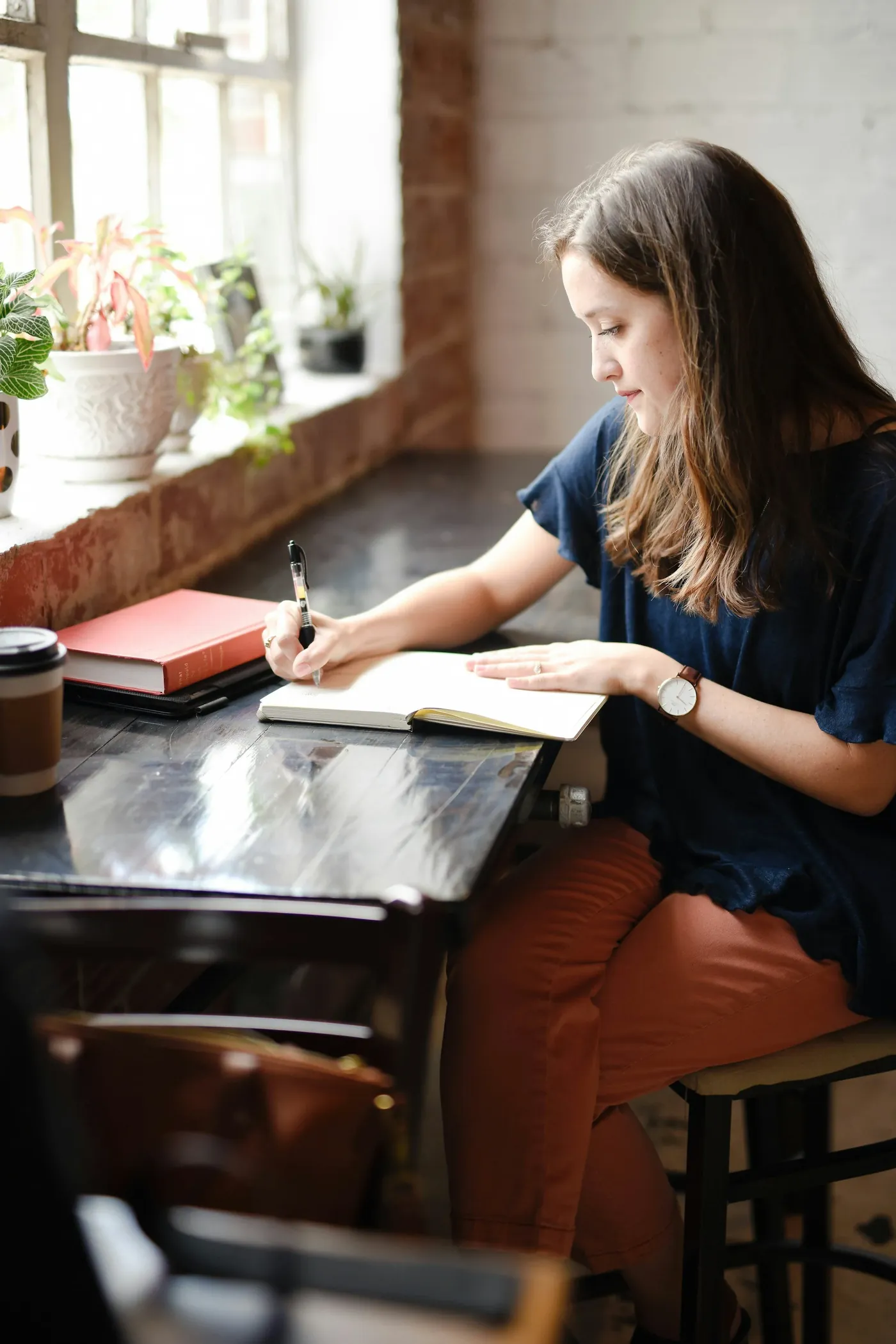 A student writing at a table